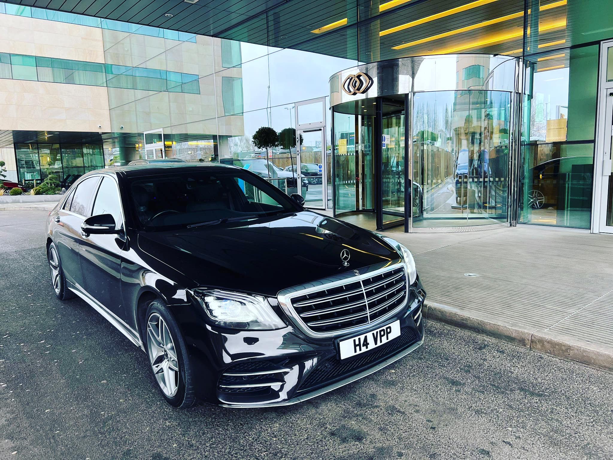 black mercedes parked outside airport