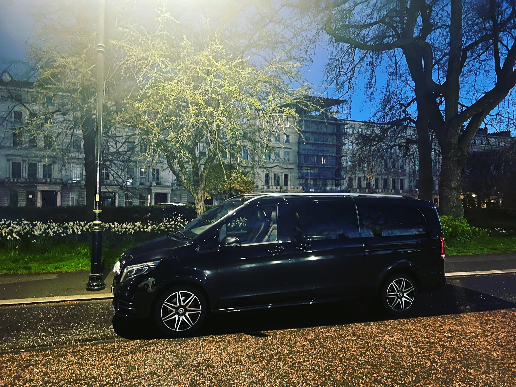 mercedes waiting in london park in the evening
