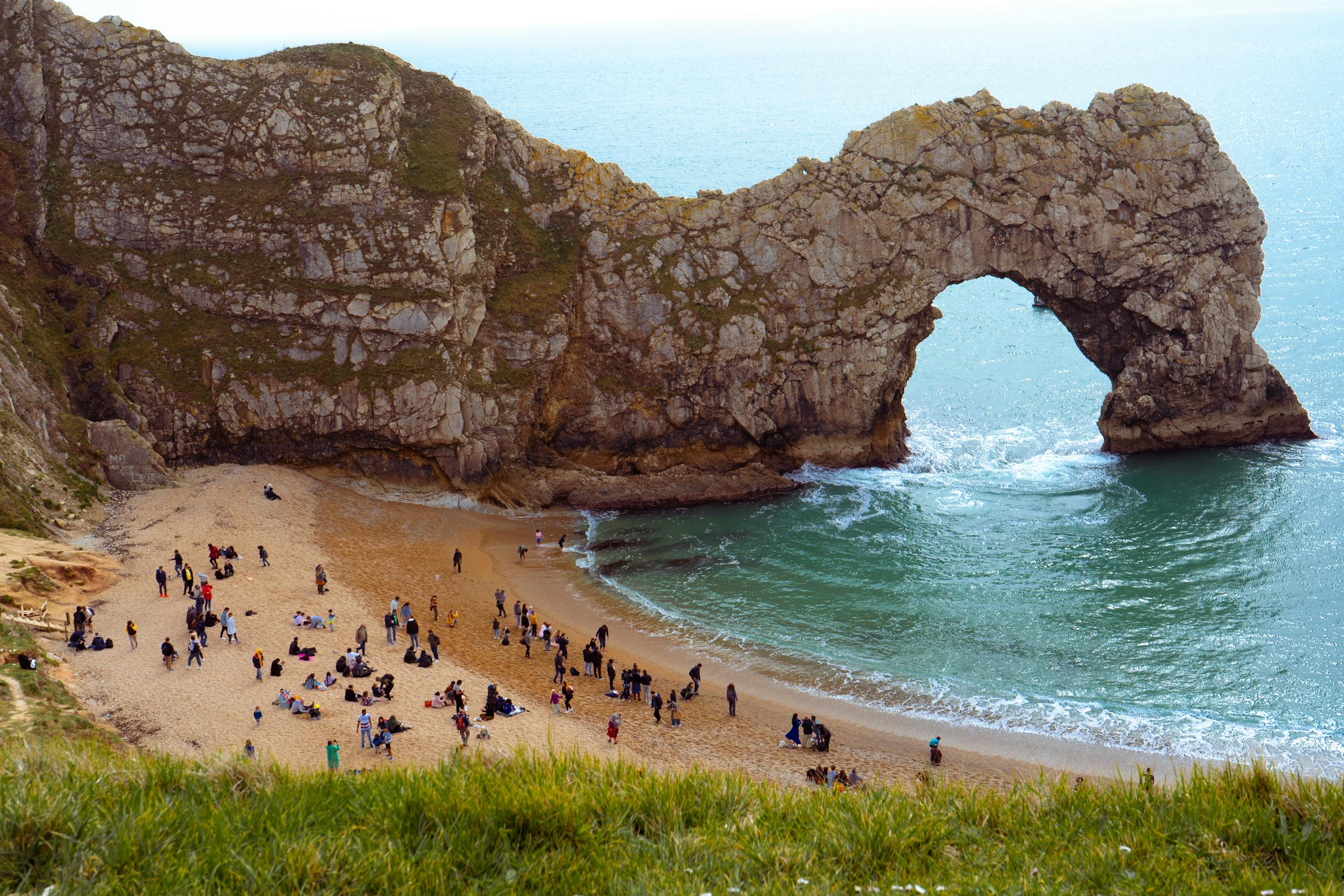 People on Beach near Natural Arch in Dorset